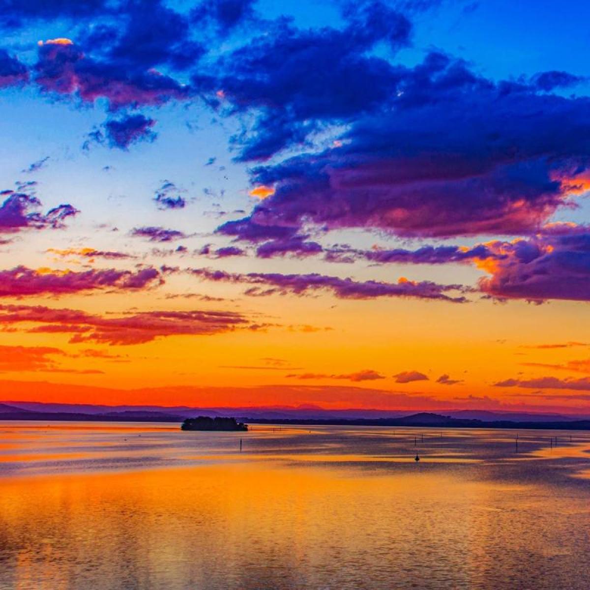 a seashore during a colorful sunset